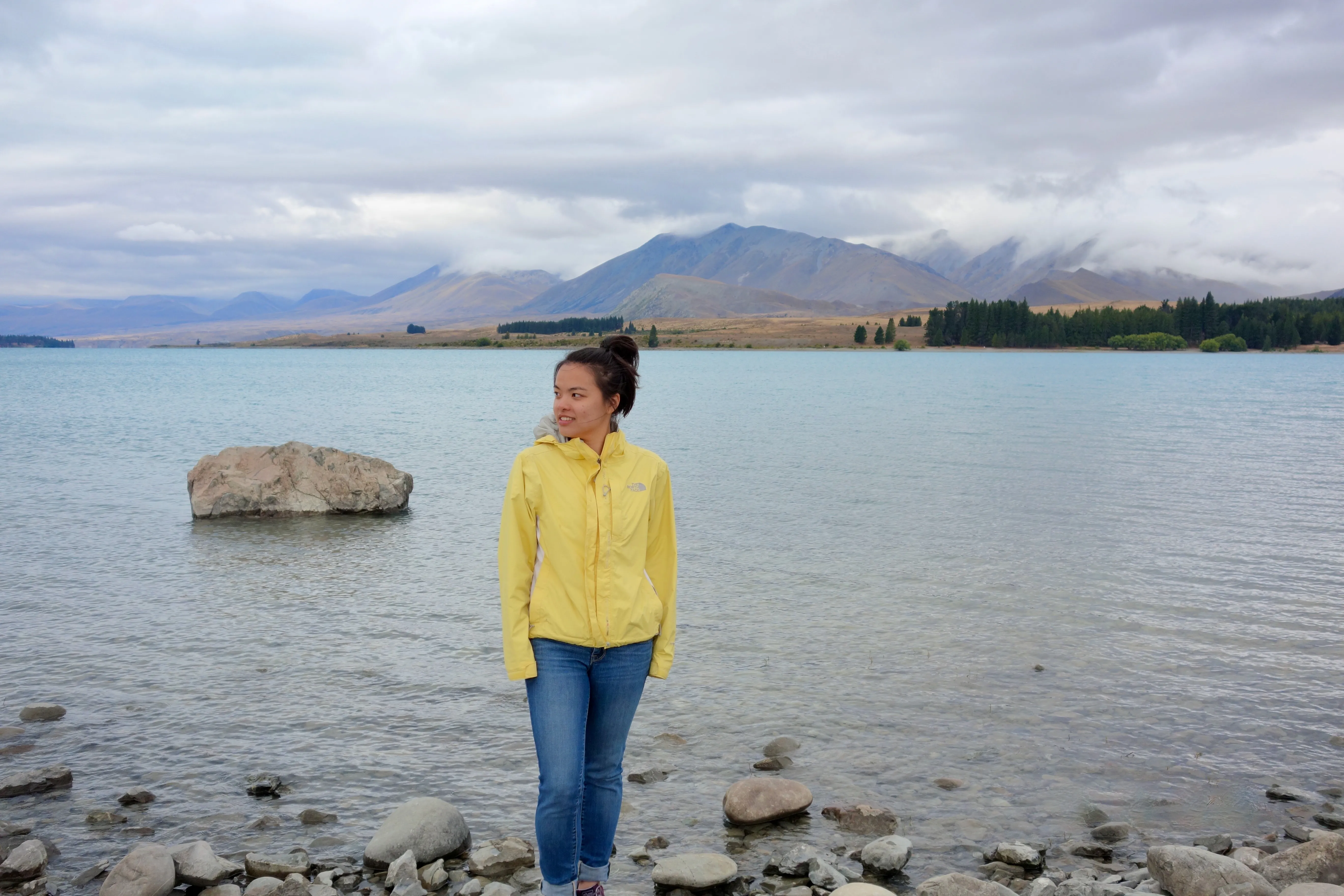 A person standing in front of a lake